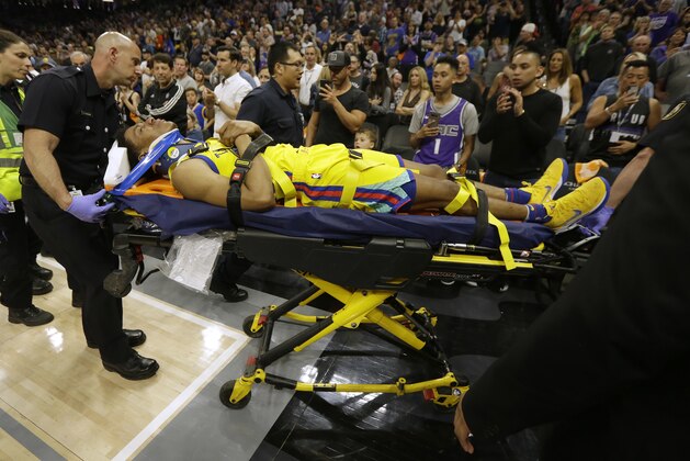 Golden State Warriors guard Patrick McCaw is taken off the court on a stretcher after falling hard to the floor late in the third quarter following a Flagrant 1 foul by Sacramento Kings's Vince Carter in an NBA basketball game Saturday, March 31, 2018, in Sacramento, Calif. The Warriors won 112-96. (AP Photo/Rich Pedroncelli)