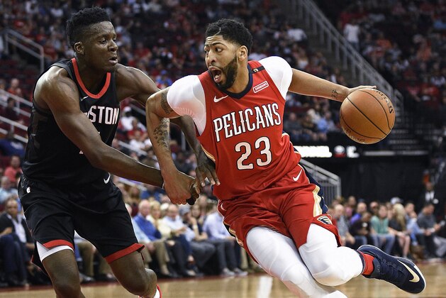 New Orleans Pelicans forward Anthony Davis (23) drives to the basket as Houston Rockets center Clint Capela, left, defends during the first half of an NBA basketball game Saturday, March 24, 2018, in Houston. (AP Photo/Eric Christian Smith)