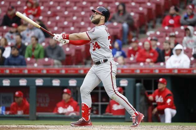 Washington Nationals' Bryce Harper watches a solo home run off Cincinnati Reds relief pitcher Raisel Iglesias during the ninth inning of a baseball game Sunday, April 1, 2018, in Cincinnati. (AP Photo/John Minchillo)