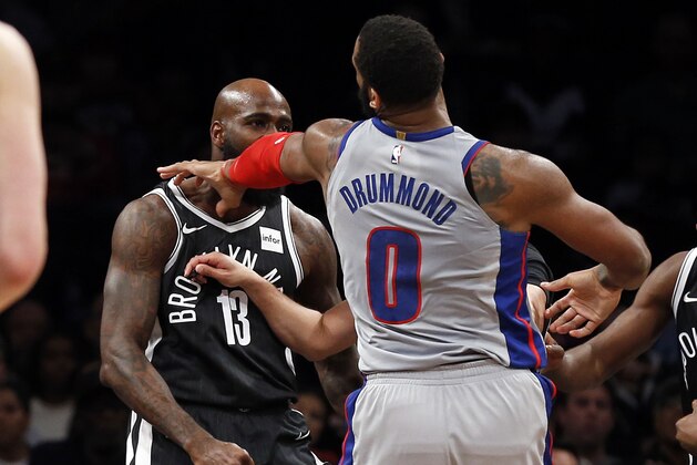 Detroit Pistons center Andre Drummond (0) pushes Brooklyn Nets forward Quincy Acy (13) during the second half of an NBA basketball game Sunday, April 1, 2018, in New York. Both Drummond and Acy were ejected as a result of the play. The Pistons defeated the Nets 108-96. (AP Photo/Adam Hunger)