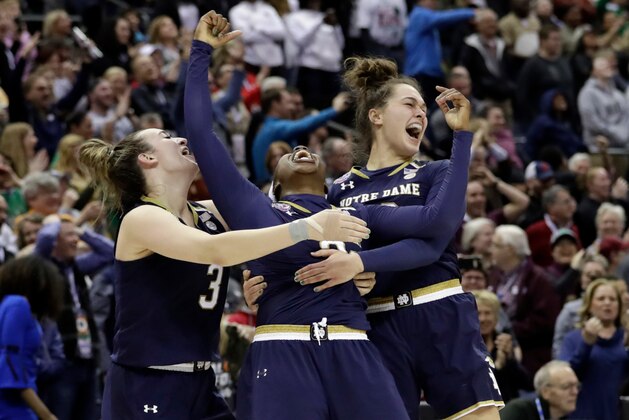 Notre Dame's Arike Ogunbowale, center, is celebrates with teammates Marina Mabrey, left, and Kathryn Westbeld after defeating Mississippi State in the final of the women's NCAA Final Four college basketball tournament, Sunday, April 1, 2018, in Columbus, Ohio. Notre Dame won 61-58. (AP Photo/Tony Dejak)