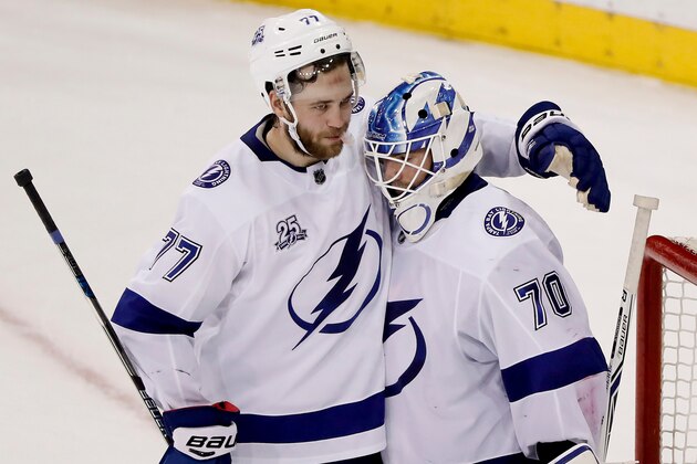 FILE - In this March 30, 2018, file photo, Tampa Bay Lightning defenseman Victor Hedman (77) celebrates with goaltender Louis Domingue (70) after the Lightning defeated the New York Rangers in an NHL hockey game in New York. A full year before he could become a free agent, Hedman told his agent he wanted to sign a long-term extension with the Lightning the first day he could. Hedman put pen to paper on an eight-year contract well before the sun went down. “It was never a doubt,” Hedman said that day. “Staying in Tampa was the No. 1 priority.” (AP Photo/Julie Jacobson, File)