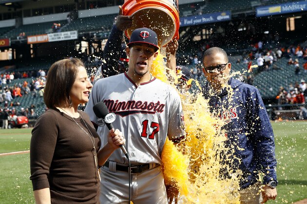 Minnesota Twins starting pitcher Jose Berrios, center, reacts as he is doused during a postgame television interview after a baseball game against the Baltimore Orioles, Sunday, April 1, 2018, in Baltimore. Berrios pitched a complete game and Minnesota won 7-0. (AP Photo/Patrick Semansky)