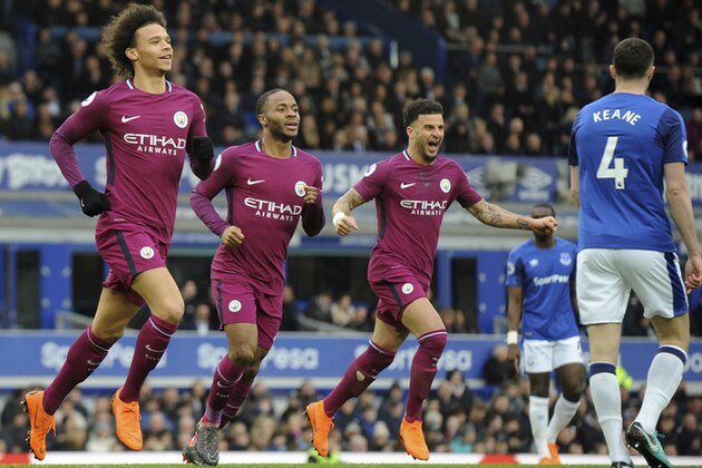 Manchester City's Leroy Sane, left, celebrates with teammates Raheem Sterling and Kyle Walker, right, after scoring his side's first goal during the English Premier League soccer match between Everton and Manchester City at Goodison Park in Liverpool, England, Saturday, March 31, 2018. (AP Photo/Rui Vieira)