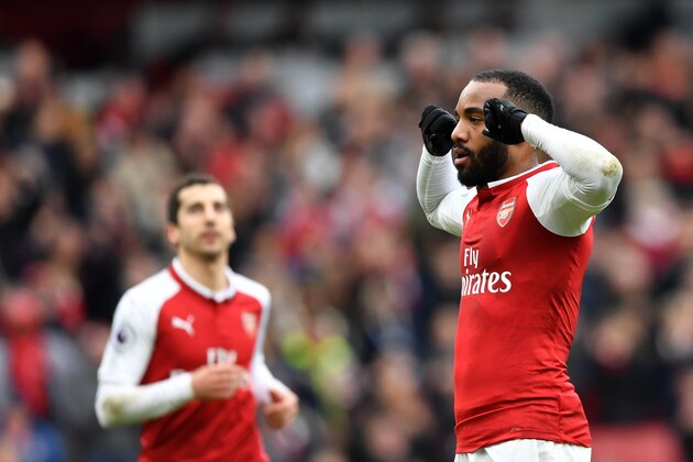 Arsenal's French striker Alexandre Lacazette (R) celebrates scoring the team's third goal during the English Premier League football match between Arsenal and Stoke City at the Emirates Stadium in London on April 1, 2018.  / AFP PHOTO / Oliver GREENWOOD / RESTRICTED TO EDITORIAL USE. No use with unauthorized audio, video, data, fixture lists, club/league logos or 'live' services. Online in-match use limited to 75 images, no video emulation. No use in betting, games or single club/league/player publications.  /         (Photo credit should read OLIVER GREENWOOD/AFP/Getty Images)