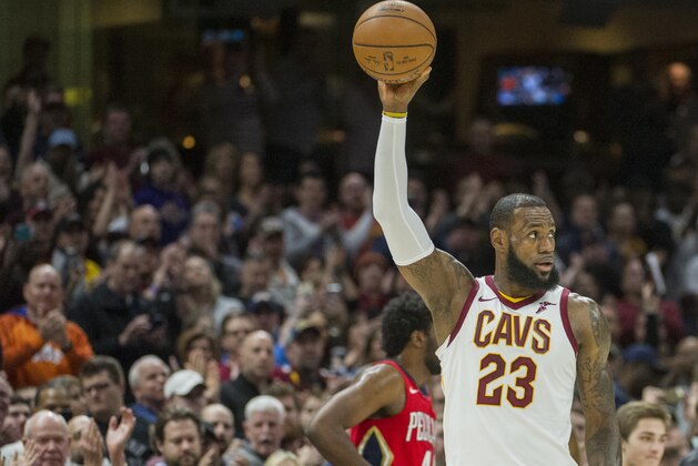 Cleveland Cavaliers' LeBron James celebrates during the first half of an NBA basketball game against the New Orleans Pelicans in Cleveland, Friday, March 30, 2018. James broke Michael Jordan's NBA record by scoring at least 10 points in his 867th straight regular-season game. (AP Photo/Phil Long)