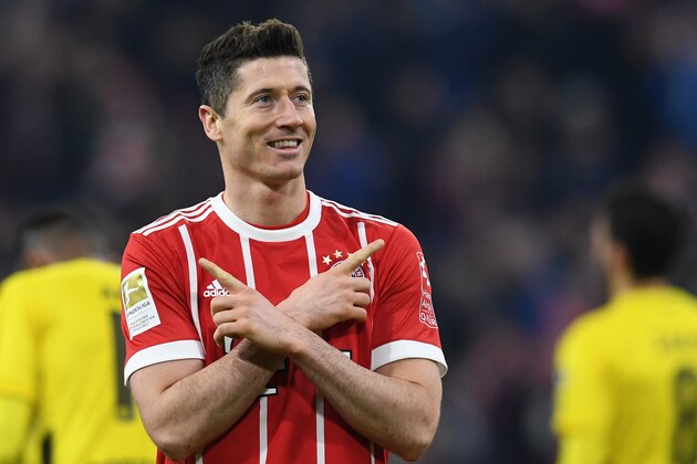 Bayern Munich's Polish striker Robert Lewandowski celebrates after scoring the sixth goal for Munich during the German first division Bundesliga football match FC Bayern Munich vs Borussia Dortmund in Munich, southern Germany, on March 31, 2018.  / AFP PHOTO / Christof STACHE / RESTRICTIONS: DURING MATCH TIME: DFL RULES TO LIMIT THE ONLINE USAGE TO 15 PICTURES PER MATCH AND FORBID IMAGE SEQUENCES TO SIMULATE VIDEO. == RESTRICTED TO EDITORIAL USE == FOR FURTHER QUERIES PLEASE CONTACT DFL DIRECTLY AT + 49 69 650050
 / RESTRICTIONS: DURING MATCH TIME: DFL RULES TO LIMIT THE ONLINE USAGE TO 15 PICTURES PER MATCH AND FORBID IMAGE SEQUENCES TO SIMULATE VIDEO. == RESTRICTED TO EDITORIAL USE == FOR FURTHER QUERIES PLEASE CONTACT DFL DIRECTLY AT + 49 69 650050        (Photo credit should read CHRISTOF STACHE/AFP/Getty Images)