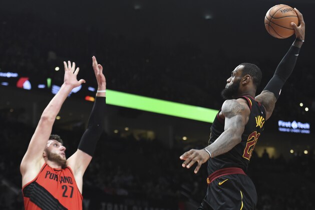 Cleveland Cavaliers forward LeBron James, right, goes up for a dunk on Portland Trail Blazers center Jusuf Nurkic, left, during the first half of an NBA basketball game in Portland, Ore., Thursday, March 15, 2018. (AP Photo/Steve Dykes)