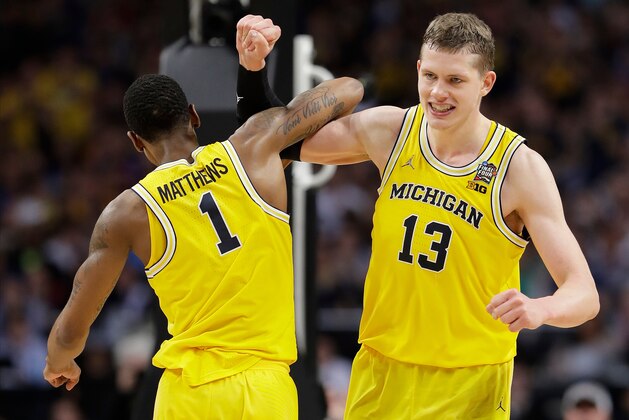 Michigan's Moritz Wagner (13) celebrates with Charles Matthews (1) during the second half in the semifinals of the Final Four NCAA college basketball tournament against Loyola-Chicago, Saturday, March 31, 2018, in San Antonio. (AP Photo/Eric Gay)