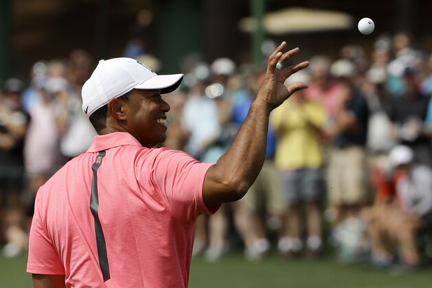 Tiger Woods gets ball from his caddie on the third hole during practice for the Masters golf tournament at Augusta National Golf Club, Monday, April 2, 2018, in Augusta, Ga. (AP Photo/Matt Slocum)