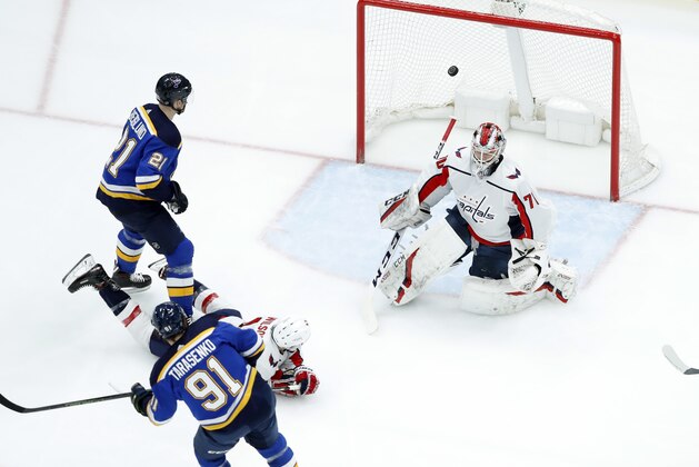 St. Louis Blues' Vladimir Tarasenko (91), of Russia, scores past Washington Capitals goaltender Braden Holtby as Blues' Patrik Berglund (21), of Sweden, watches during the first period of an NHL hockey game Monday, April 2, 2018, in St. Louis. (AP Photo/Jeff Roberson)