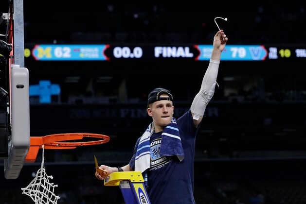 Villanova's Donte DiVincenzo cuts the net as he celebrates after the championship game of the Final Four NCAA college basketball tournament against Michigan, Monday, April 2, 2018, in San Antonio. Villanova won 79-62. (AP Photo/David J. Phillip)