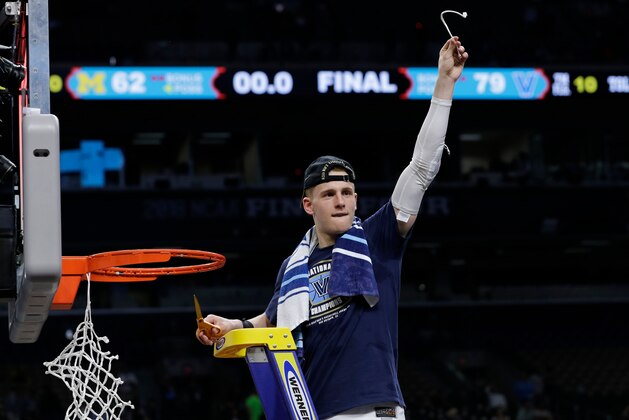 Villanova's Donte DiVincenzo cuts the net as he celebrates after the championship game of the Final Four NCAA college basketball tournament against Michigan, Monday, April 2, 2018, in San Antonio. Villanova won 79-62. (AP Photo/David J. Phillip)