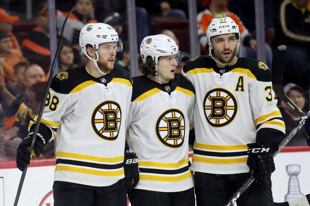 PHILADELPHIA, PA - APRIL 1: David Pastrnak #88 of the Boston Bruins celebrates scoring a third period goal with teammates Danton Heinen #43 and Patrice Bergeron #37 against the Philadelphia Flyers at Wells Fargo Center on April 1, 2018 in Philadelphia, Pennsylvania. (Photo by Rob Carr/Getty Images)