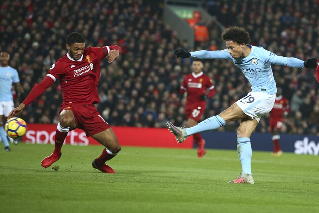 CORRECTS NAME OF PLAYER AND TEAM - Manchester City's Leroy Sane, right, scores his side's first goal during the English Premier League soccer match between Liverpool and Manchester City at Anfield Stadium, in Liverpool, England, Sunday Jan. 14, 2018. (AP Photo/Dave Thompson)