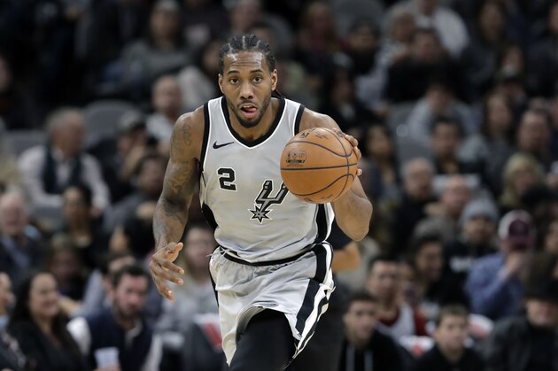 San Antonio Spurs forward Kawhi Leonard (2) moves the ball up court during the second half of an NBA basketball game against the Denver Nuggets, Saturday, Jan. 13, 2018, in San Antonio. San Antonio won 112-80. (AP Photo/Eric Gay)