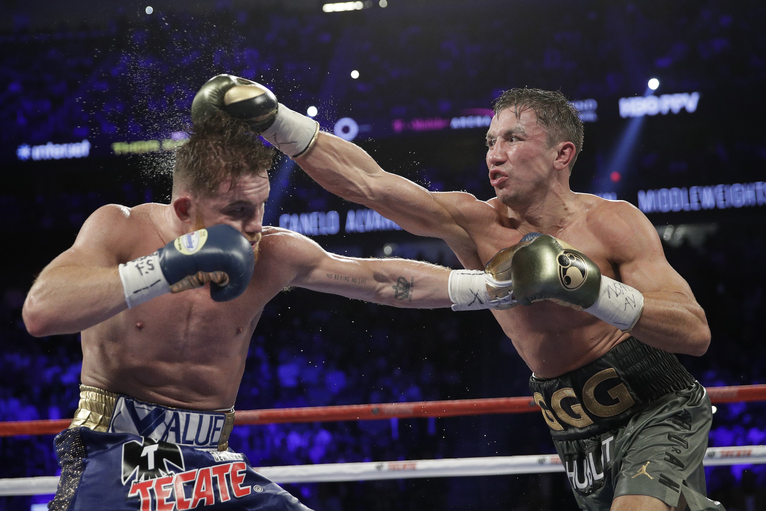 Gennady Golovkin, right, connects with a right to Canelo Alvarez during a middleweight title fight Sunday, Sept. 17, 2017, in Las Vegas. (AP Photo/John Locher)