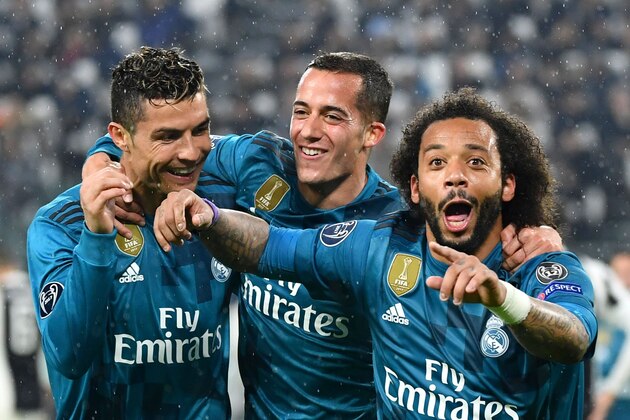 Real Madrid's Brazilian defender Marcelo (R) celebrates after scoring with Real Madrid's Spanish midfielder Lucas Vazquez and Real Madrid's Portuguese forward Cristiano Ronaldo (L) during the UEFA Champions League quarter-final first leg football match between Juventus and Real Madrid at the Allianz Stadium in Turin on April 3, 2018. / AFP PHOTO / Alberto PIZZOLI        (Photo credit should read ALBERTO PIZZOLI/AFP/Getty Images)