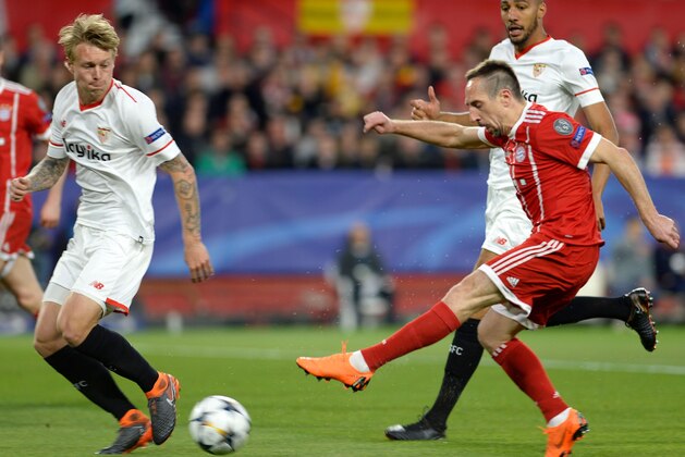 Bayern Munich's French midfielder Franck Ribery (R bottom) shoots beside Sevilla's French midfielder Steven N'Zonzi during the UEFA Champions League quarter-final first leg football match between Sevilla FC and Bayern Munich at the Ramon Sanchez Pizjuan Stadium in Sevilla on April 3, 2018. / AFP PHOTO / CRISTINA QUICLER        (Photo credit should read CRISTINA QUICLER/AFP/Getty Images)