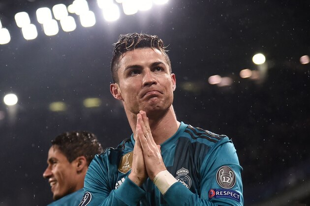 Real Madrid's Portuguese forward Cristiano Ronaldo celebrates after scoring a second goal during the UEFA Champions League quarter-final first leg football match between Juventus and Real Madrid at the Allianz Stadium in Turin on April 3, 2018. / AFP PHOTO / Marco BERTORELLO        (Photo credit should read MARCO BERTORELLO/AFP/Getty Images)