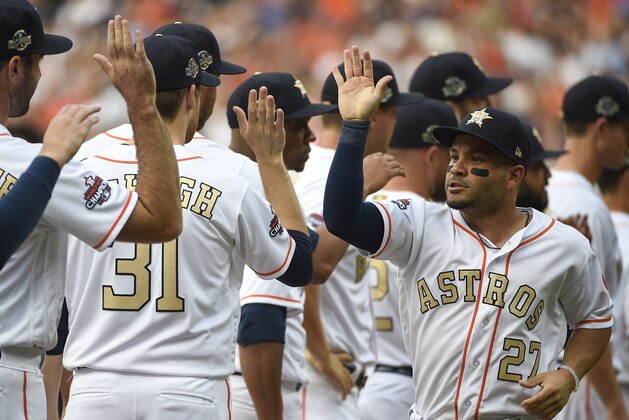 Houston Astros' Jose Altuve (27) high-fives teammates during player introductions before a baseball game against the Baltimore Orioles, Monday, April 2, 2018, in Houston. (AP Photo/Eric Christian Smith)