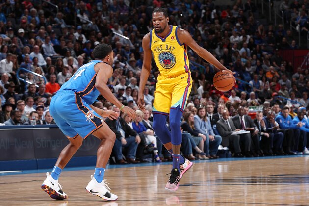 OKLAHOMA CITY, OK - APRIL 3: Kevin Durant #35 of the Golden State Warriors handles the ball against Josh Huestis #34 of the Oklahoma City Thunder during the game on April 3, 2018 at Chesapeake Energy Arena in Oklahoma City, Oklahoma. NOTE TO USER: User expressly acknowledges and agrees that, by downloading and or using this photograph, User is consenting to the terms and conditions of the Getty Images License Agreement. Mandatory Copyright Notice: Copyright 2018 NBAE (Photo by Joe Murphy/NBAE via Getty Images)