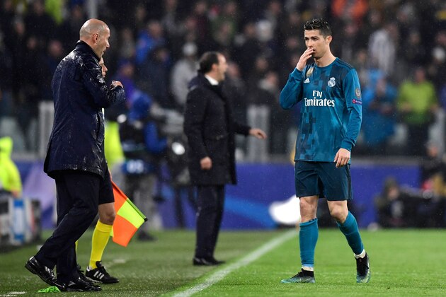 Real Madrid's Portuguese forward Cristiano Ronaldo speaks with Real Madrid's French coach Zinedine Zidane (L) during the UEFA Champions League quarter-final first leg football match between Juventus and Real Madrid at the Allianz Stadium in Turin on April 3, 2018. / AFP PHOTO / JAVIER SORIANO        (Photo credit should read JAVIER SORIANO/AFP/Getty Images)