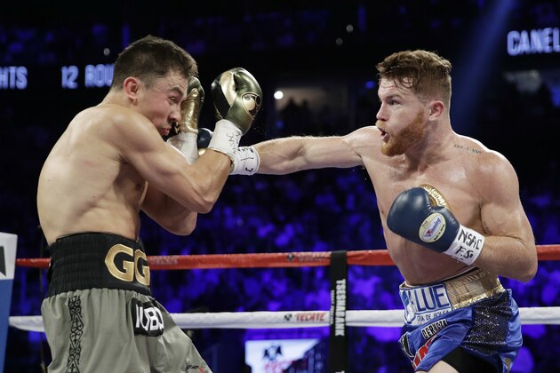 Canelo Alvarez, right, throws a right at Gennady Golovkin during a middleweight boxing bout Saturday, Sept. 16, 2017, in Las Vegas. (AP Photo/John Locher)