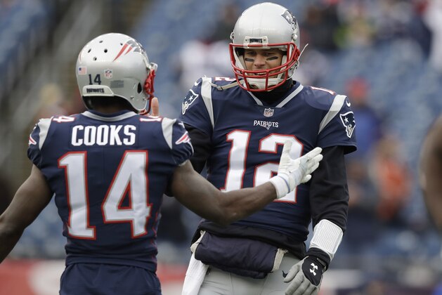 New England Patriots quarterback Tom Brady (12) talks to wide receiver Brandin Cooks (14) as they warm up before an NFL football game against the Buffalo Bills, Sunday, Dec. 24, 2017, in Foxborough, Mass. (AP Photo/Charles Krupa)