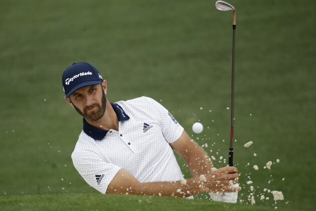 Dustin Johnson hits from a bunker on the second hole during a practice round for the Masters golf tournament Wednesday, April 4, 2018, in Augusta, Ga. (AP Photo/Chris Carlson)