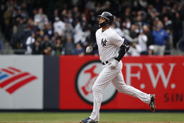 New York Yankees' Giancarlo Stanton runs the bases hitting a two-run home run against the Tampa Bay Rays in the first inning of a baseball game  at Yankee Stadium in New York, Wednesday, April 4, 2018. (AP Photo/Kathy Willens)