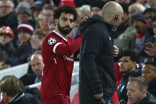 Liverpool's Mohamed Salah leaves the pitch after getting injured during the Champions League quarter final first leg soccer match between Liverpool and Manchester City at Anfield stadium in Liverpool, England, Wednesday, April 4, 2018. (AP Photo/Dave Thompson)
