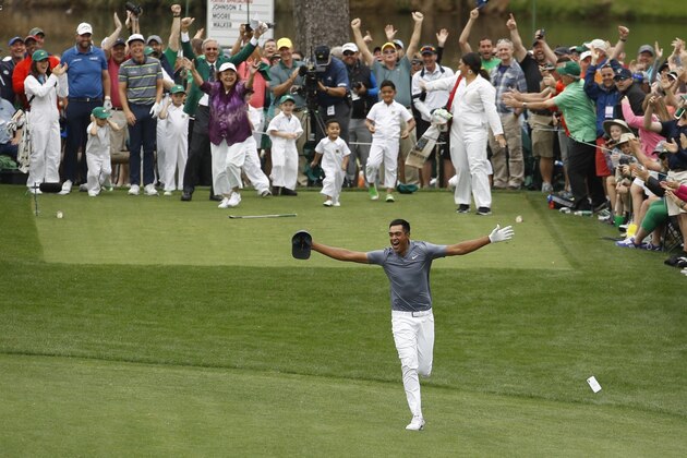 Tony Finau reacts after hitting a hole in one on the seventh home during the par three competition at the Masters golf tournament Wednesday, April 4, 2018, in Augusta, Ga. (AP Photo/Charlie Riedel)
