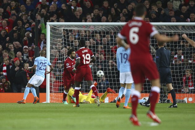Liverpool's Mohamed Salah, second left, after he scores the opening goalnduring the Champions League quarter final first leg soccer match between Liverpool and Manchester City at Anfield stadium in Liverpool, England, Wednesday, April 4, 2018. (AP Photo/Dave Thompson)