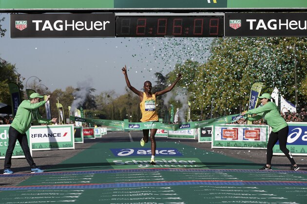 Paul Lonyangata of Kenya crosses the finish line to win the 41st Paris Marathon men's race in Paris, Sunday, April 9, 2017. (AP Photo/Thibault Camus)