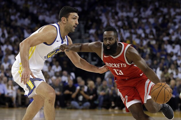 Houston Rockets' James Harden, right, drives the ball against Golden State Warriors' Zaza Pachulia during the first quarter of an NBA basketball game Tuesday, Oct. 17, 2017, in Oakland, Calif. (AP Photo/Ben Margot)