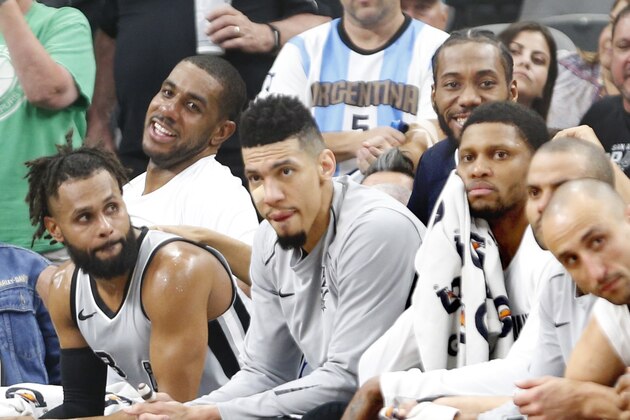 SAN ANTONIO,TX - MARCH 17 :  LaMarcus Aldridge #12 of the San Antonio Spurs and Kawhi Leonard #2(in street clothes)  of the San Antonio Spurs share a laugh in closing minute of game against the Minnesota Timberwolves at AT&T Center on March 17, 2018  in San Antonio, Texas.  NOTE TO USER: User expressly acknowledges and agrees that , by downloading and or using this photograph, User is consenting to the terms and conditions of the Getty Images License Agreement. (Photo by Ronald Cortes/Getty Images)