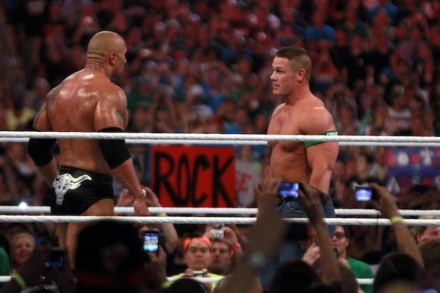 COMMERCIAL IMAGE - In this photograph taken by AP Images for WWE, Dwyane 'The Rock' Johnson, left, and John Cena face off at WrestleMania XXVIII in Sun Life Stadium on Sunday, April 1, 2012 in Miami. (Marc Serota/AP Images for WWE)