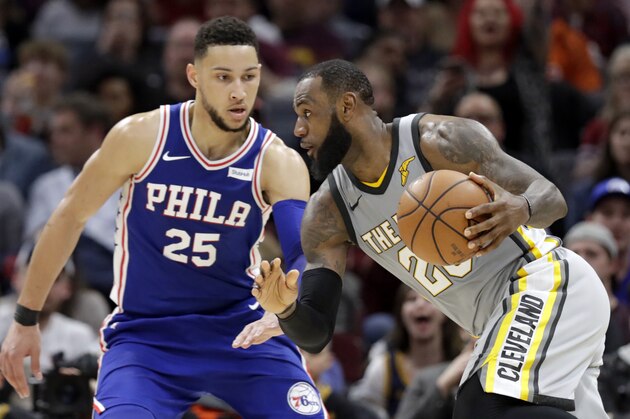 Cleveland Cavaliers' LeBron James (23) drives abasing Philadelphia 76ers' Ben Simmons (25), from Australia, in the second half of an NBA basketball game, Thursday, March 1, 2018, in Cleveland. (AP Photo/Tony Dejak)