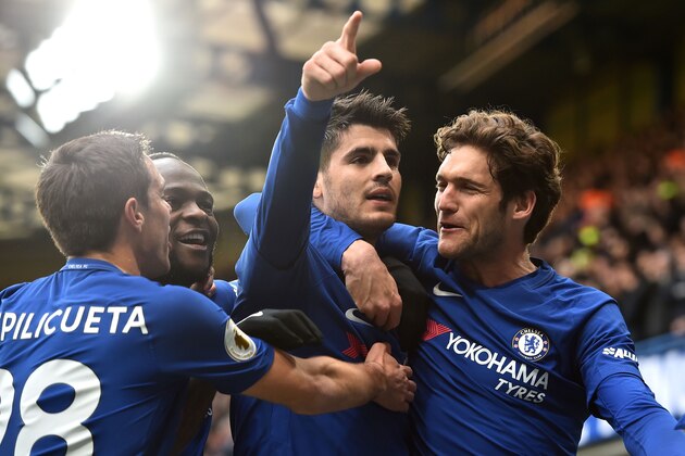 Chelsea's Spanish striker Alvaro Morata (C) celebrates with Chelsea's Spanish defender Cesar Azpilicueta (L), Chelsea's Nigerian midfielder Victor Moses (2nd L) and Chelsea's Spanish defender Marcos Alonso (R) after scoring the opening goal of the English Premier League football match between Chelsea and Tottenham Hotspur at Stamford Bridge in London on April 1, 2018. / AFP PHOTO / Glyn KIRK / RESTRICTED TO EDITORIAL USE. No use with unauthorized audio, video, data, fixture lists, club/league logos or 'live' services. Online in-match use limited to 75 images, no video emulation. No use in betting, games or single club/league/player publications.  /         (Photo credit should read GLYN KIRK/AFP/Getty Images)