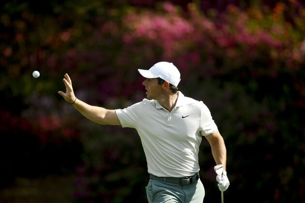 Rory McIlroy, of Northern Ireland, catches a ball from his caddie on the 13th hole during practice for the Masters golf tournament at Augusta National Golf Club, Tuesday, April 3, 2018, in Augusta, Ga. (AP Photo/Charlie Riedel)