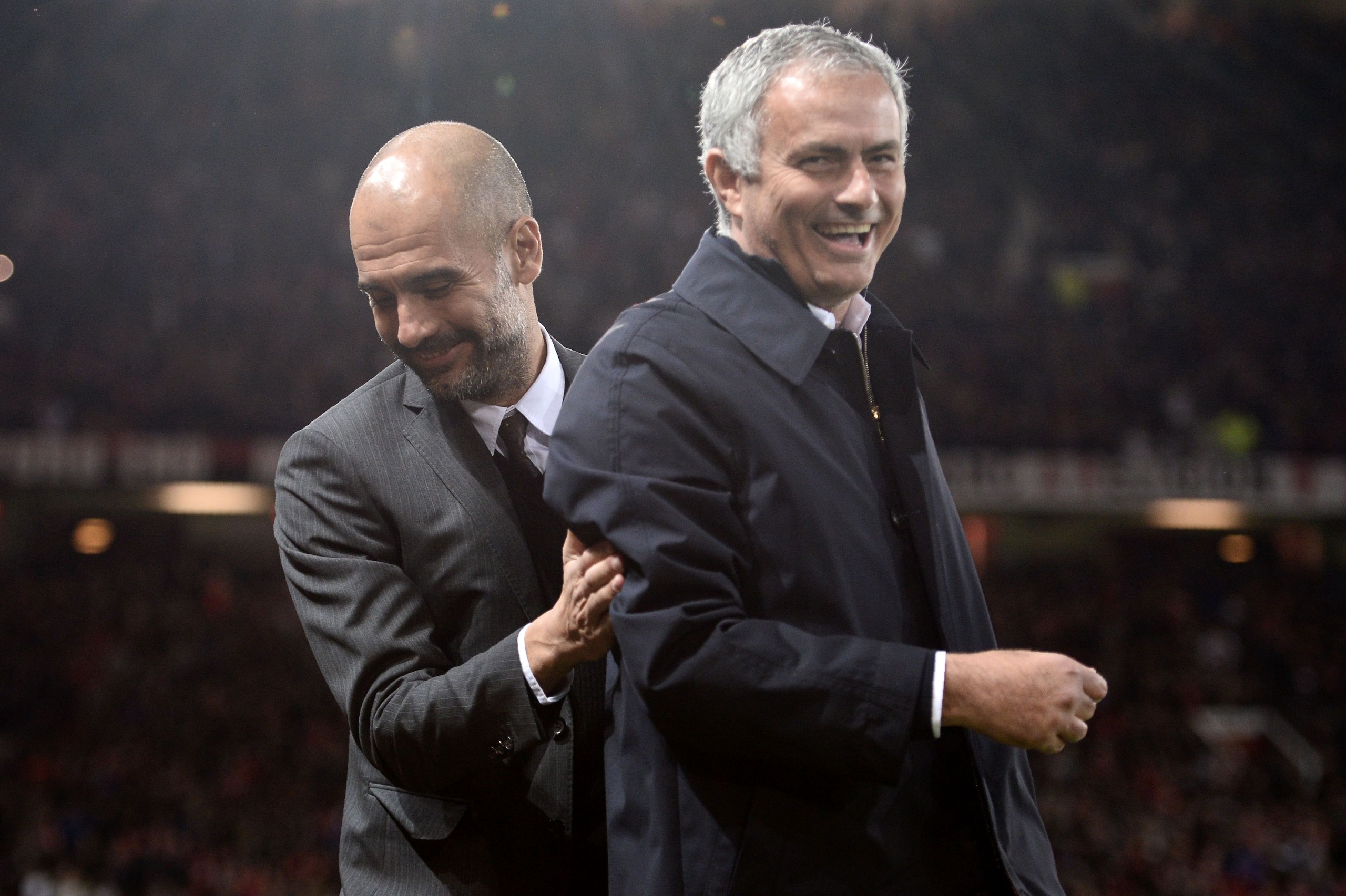 Manchester United's Portuguese manager Jose Mourinho (R) and Manchester City's Spanish manager Pep Guardiola share a joke ahead of the EFL (English Football League) Cup fourth round match between Manchester United and Manchester City at Old Trafford in Manchester, north west England on October 26, 2016. / AFP / Oli SCARFF / RESTRICTED TO EDITORIAL USE. No use with unauthorized audio, video, data, fixture lists, club/league logos or 'live' services. Online in-match use limited to 75 images, no video emulation. No use in betting, games or single club/league/player publications.  /         (Photo credit should read OLI SCARFF/AFP/Getty Images)
