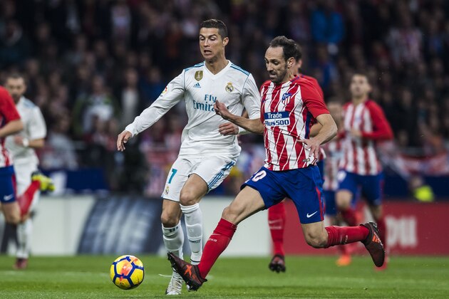 MADRID, SPAIN - NOVEMBER 18: Cristiano Ronaldo of Real Madrid competes for the ball with Juan Francisco Torres Belen, Juanfran, of Atletico de Madrid during the La Liga 2017-18 match between Atletico de Madrid and Real Madrid at Wanda Metropolitano  on November 18 2017 in Madrid, Spain. (Photo by Power Sport Images/Getty Images)