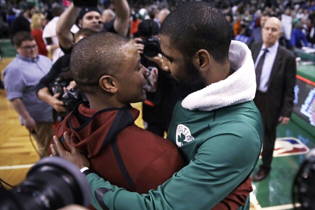 Boston Celtics guard Kyrie Irving, right, embraces Cleveland Cavaliers guard Isaiah Thomas after an NBA basketball game in Boston, Wednesday, Jan. 3, 2018. The Celtics won 102-88. (AP Photo/Charles Krupa)