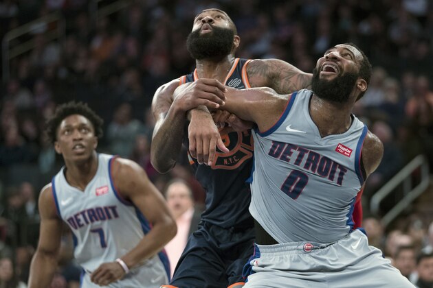 Detroit Pistons center Andre Drummond (0) and New York Knicks center Kyle O'Quinn, center, fight for position during a free throw during the second half of an NBA basketball game, Saturday, March 31, 2018, at Madison Square Garden in New York. (AP Photo/Mary Altaffer)