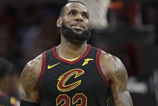 Cleveland Cavaliers' LeBron James smiles in the final seconds in the second half of an NBA basketball game against the Washington Wizards, Thursday, April 5, 2018, in Cleveland. (AP Photo/Tony Dejak)