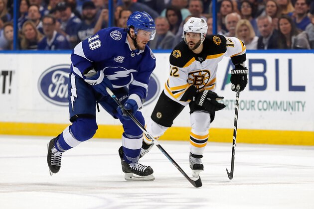 TAMPA, FL - APRIL  3: J.T. Miller #10 of the Tampa Bay Lightning looks to avoid a check by Brian Gionta #12 of the Boston Bruins during the third period of the game at the Amalie Arena on April 3, 2018 in Tampa, Florida. (Photo by Mike Carlson/Getty Images) *** Local Caption *** Brian Gionta;J.T. Miller