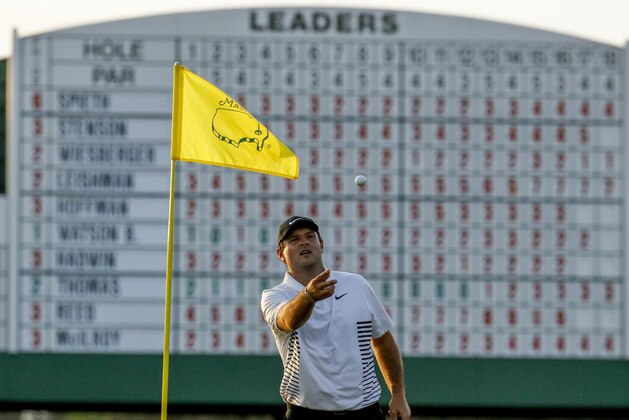 Patrick Reed catches a ball in the 17th green during the second round at the Masters golf tournament Friday, April 6, 2018, in Augusta, Ga. (AP Photo/Charlie Riedel)