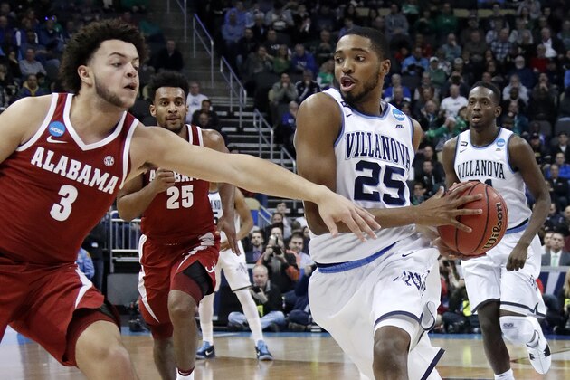 Villanova 's Mikal Bridges (25) drives the lane past Alabama 's Alex Reese (3) for tw0-points during the first half of an NCAA men's college basketball tournament second-round game, in Pittsburgh, Saturday, March 17, 2018. Villanova won 81-58. (AP Photo/Gene J. Puskar)