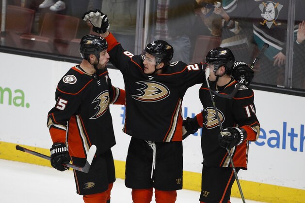 Anaheim Ducks' Brandon Montour, center, celebrates his goal with Ryan Getzlaf, left, and Adam Henrique during the third period of an NHL hockey game against the New Jersey Devils Sunday, March 18, 2018, in Anaheim, Calif. The Ducks won 4-2. (AP Photo/Jae C. Hong)